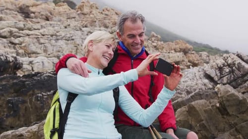 Happy Couple Taking Selfie on Rocky Coastline
