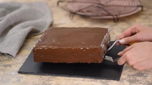 Chef Baker Putting Chocolate Cake on Cake Dish.