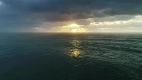 Aerial View on Big Waves and Dramatic Sunset Sky