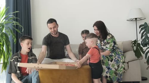 Family Enjoys Opening Pizza Together at Home