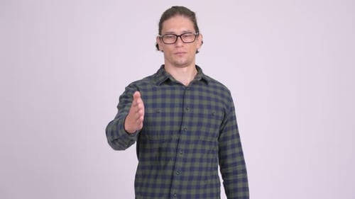 Man Extends Hand for Handshake in Studio