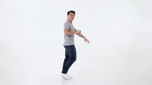 Young Man Dancing in White Studio