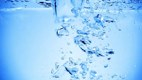 Ice Cubes Falling into Refreshing Water