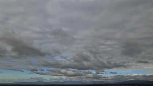 Layers of Gray Clouds with Glimpses of Blue Sky