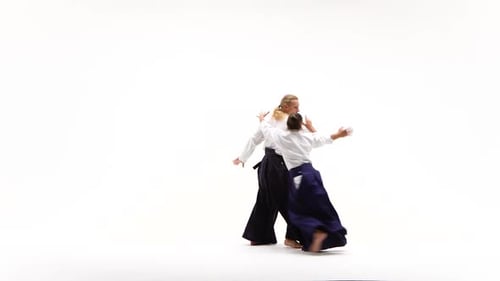 Man and Woman in White Keikogi Showing Aikido Techniques, Isolated on White