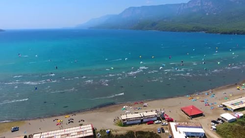 Kiteboarding, Kitesurfing Kiters and Kiteboarders are Pulled Across Sea Water by a Wind Power Kite