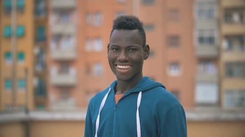 Young Man Smiling Portrait in Urban Setting