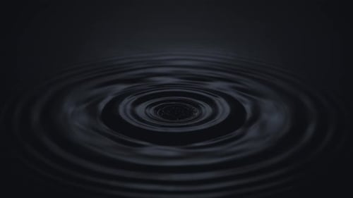 Water Drop Creates Ripples in Dark Liquid