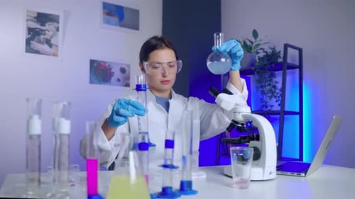 Woman Scientist Mixing Chemicals in a Laboratory