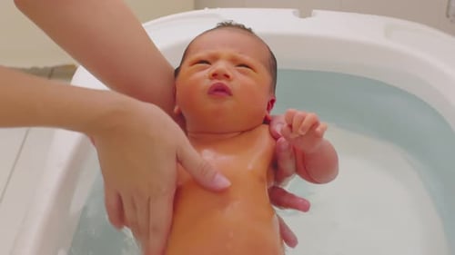 Infant Getting a Bath at Home