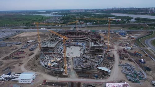 Assembled Arena Building and Cranes at Construction Site
