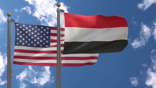 United States and Yemen Flags Waving in Blue Sky