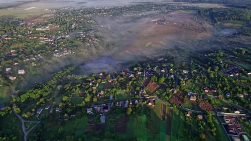 Sunrise with Fog Above Village in Morning