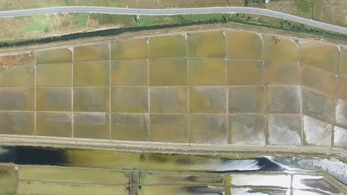 View from above of paved road passing the salt ponds on Pag island, Croatia