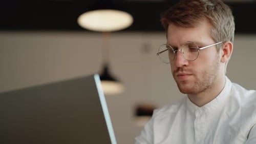 Man Working on Laptop in Modern Office