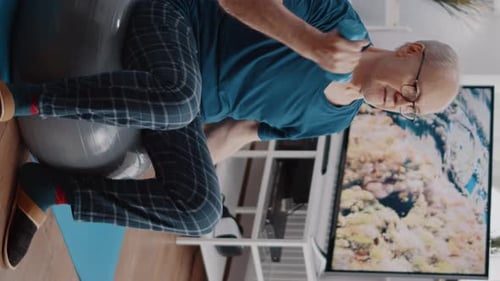 Senior Man Working Out at Home With Dumbbells