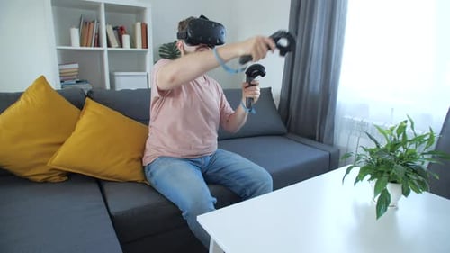 Adult Interacting with Virtual Reality Headset at Home