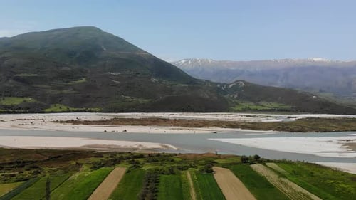 Aerial Drone Footage View Flight Over Mountain with Forests Fields and River in Sunrise Soft Light