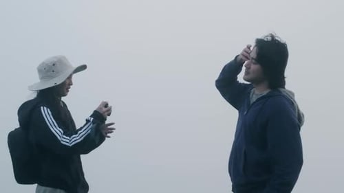 Couples of Asian tourists enjoy taking photos on top of the mountain.