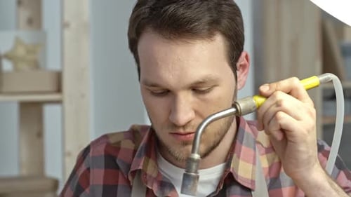 Man Using Tool in Workshop Close Up