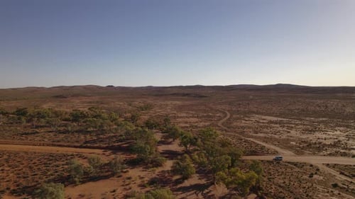 Remote Desert Landscape with Road and Vehicle