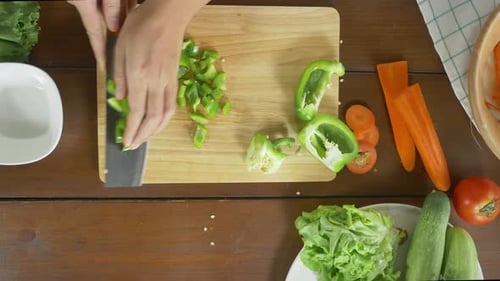 Hands Chopping Green Pepper for Salad Preparation