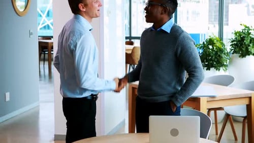Men Shaking Hands During Office Business Meeting
