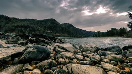 Time Lapse Shot of a River Near Mountain Forest. Huge Rocks and Fast Clouds Movenings. Horizontal