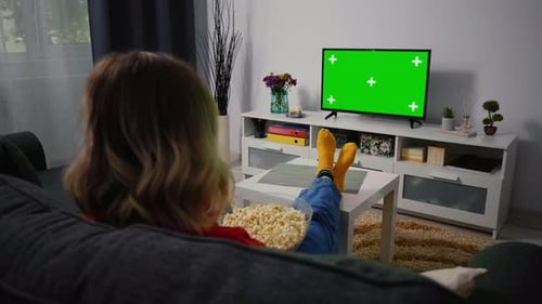 Green Screen Chroma Key Television. Woman watching Tv resting in the evening.