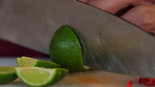 Lime Being Sliced on Cutting Board Close Up