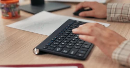 Closeup of a Black Keyboard From a Computer Standing on a Wooden Desk on It a Working Woman Young