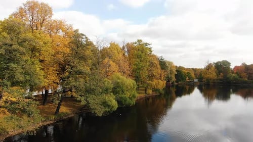 Autumn City Park with Bright Yellow and Red Foliage and Lake Aerial View