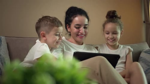 Family Togetherness: Mother and Children Using Tablet