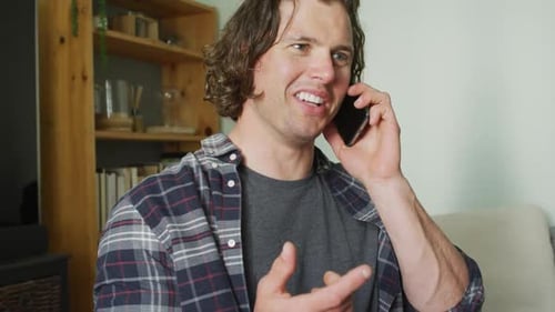 Smiling Man Talking on Phone in Living Room