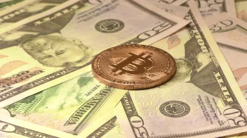 Bitcoin Cryptocurrency on Top of Fifty Dollar Bills