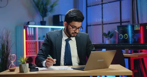 Young Adult Businessman Working at Modern Desk