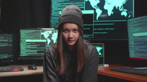Young Adult in Front of Computer Screens