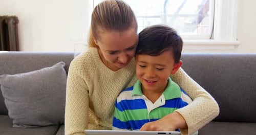 Woman and Child Using Tablet at Home