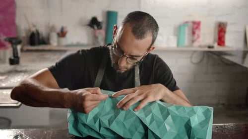 Close-up: a man works with a blade. Production of decorative elements. Workshop.