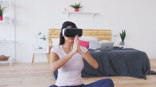 Woman Using VR Headset For Yoga Indoors