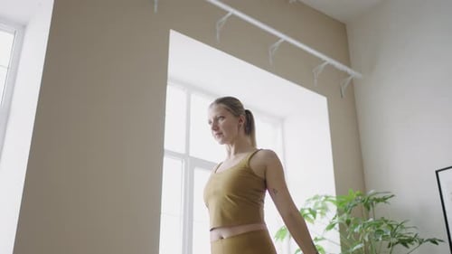 Woman Exercising with Resistance Band at Home