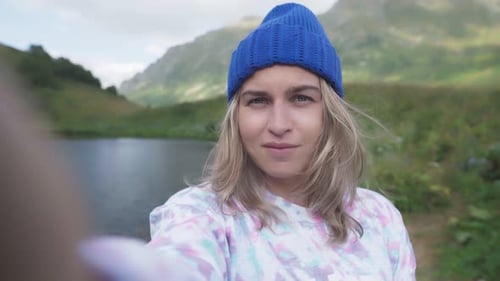 Woman Taking Selfie in Front of Lake