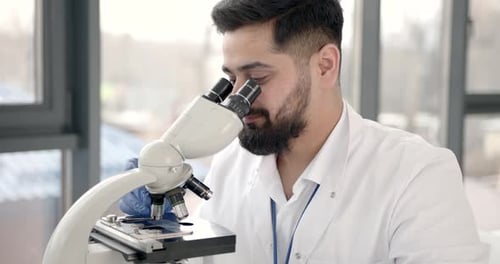 Lab Male Worker Do Research with Microscope
