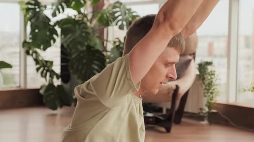 Man and Woman Doing Yoga Stretches Indoors