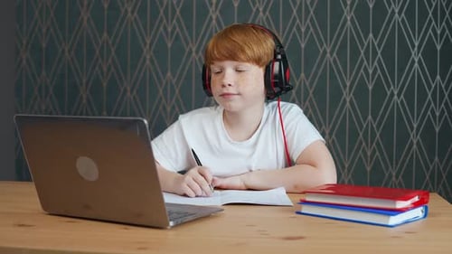 Focused Child Studying Online at Home