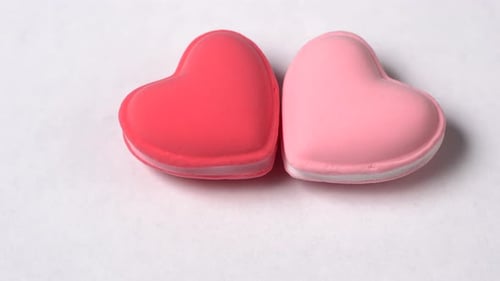 Two Hearts Rotate on a White Background