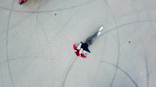 Motorcycle drive around woman. Top view of motorcycles driving around lying woman