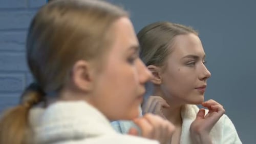 Beautiful Female Teenager Applying Face Cream, Beauty Care for Young Skin