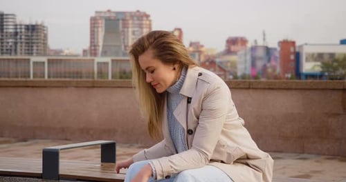 Distressed Woman with Head in Hands on Bench