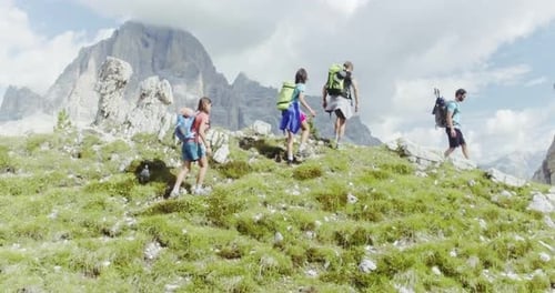 Aerial Flight Above People Hiking Along Trail Path in Sunny Day